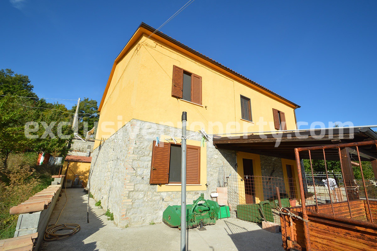 Detached country house with land and wooden veranda for sale in Italy 4