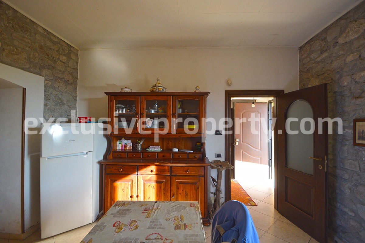 Detached country house with land and wooden veranda for sale in Italy 9