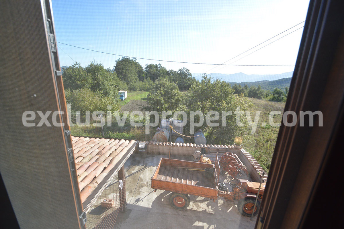 Detached country house with land and wooden veranda for sale in Italy 17